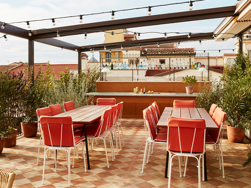 View of Hoxton Florence rooftop venue, featuring a covered roof section and bar, available for hire.