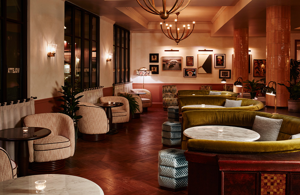 Various seating arrangements in dim lighting, complemented by soft-colored pastel walls.