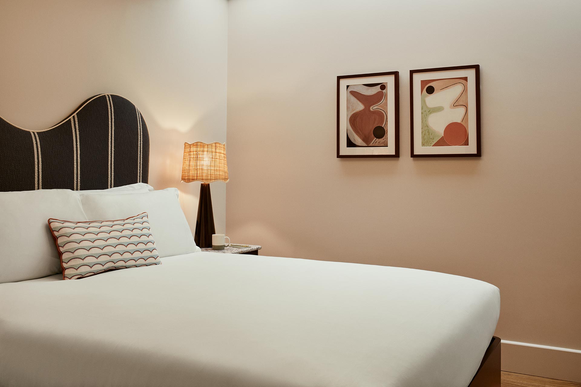 Interior of Hideout room at new hotel in Shepherd's Bush showing wall art and comfortable bed.
