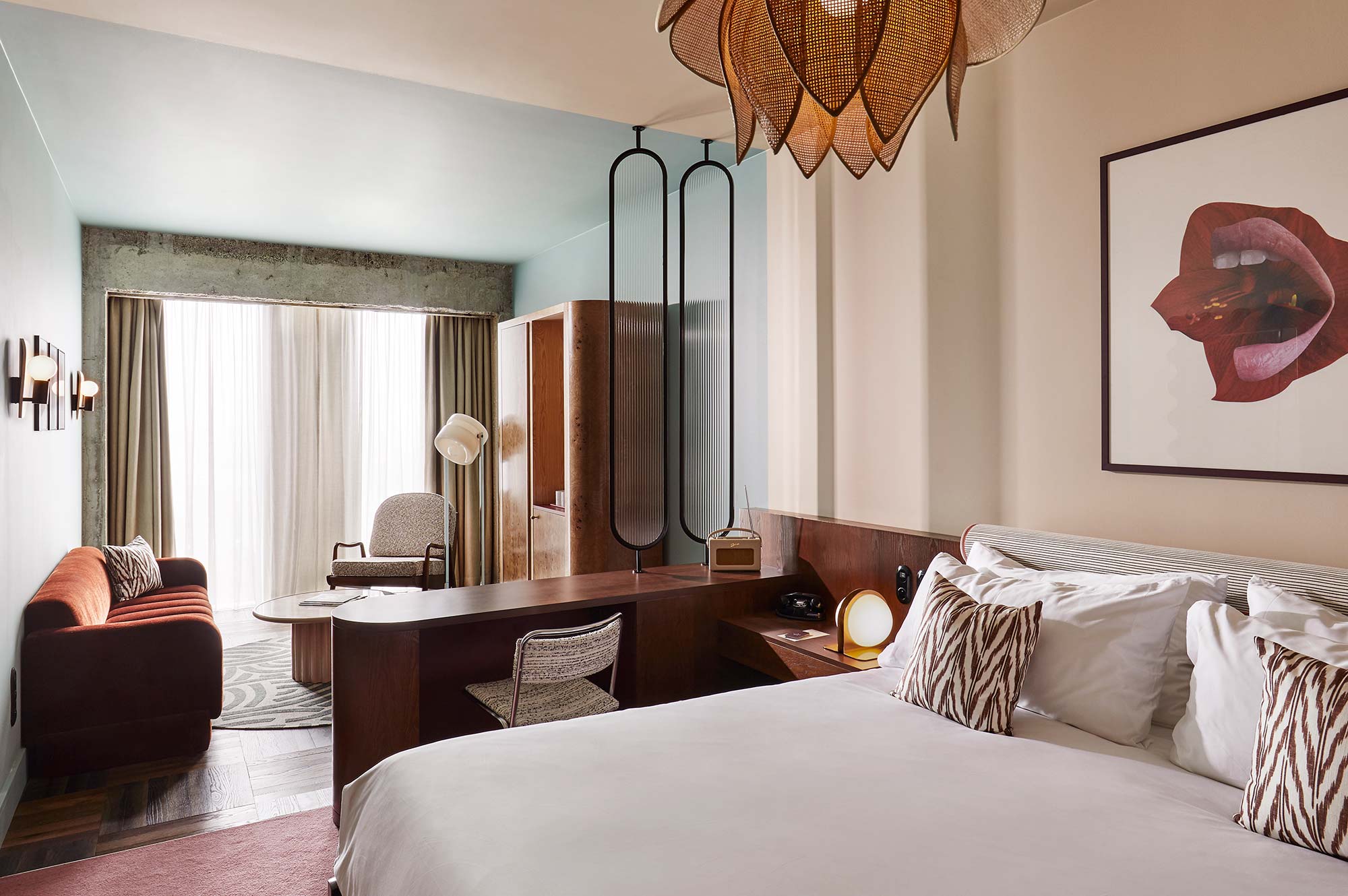 Interior of a bedroom at The Hoxton Brussels with queen bed, sofa, wardrobe and plenty of natural light.