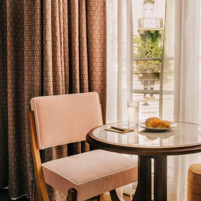 Fresh pastry served on a coffee table with views of Vienna through the bedroom window